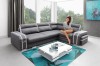 Graues Ecksofa mit weißen Akzenten in modernem Wohnzimmer.