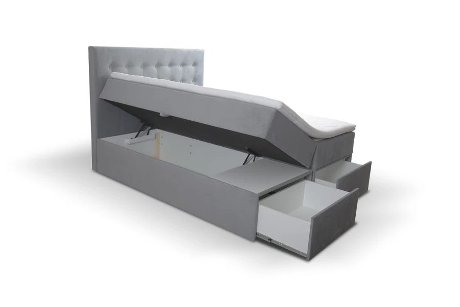 Graues Boxspringbett mit Knopfheftung, offenem Bettkasten und zwei Schubladen.