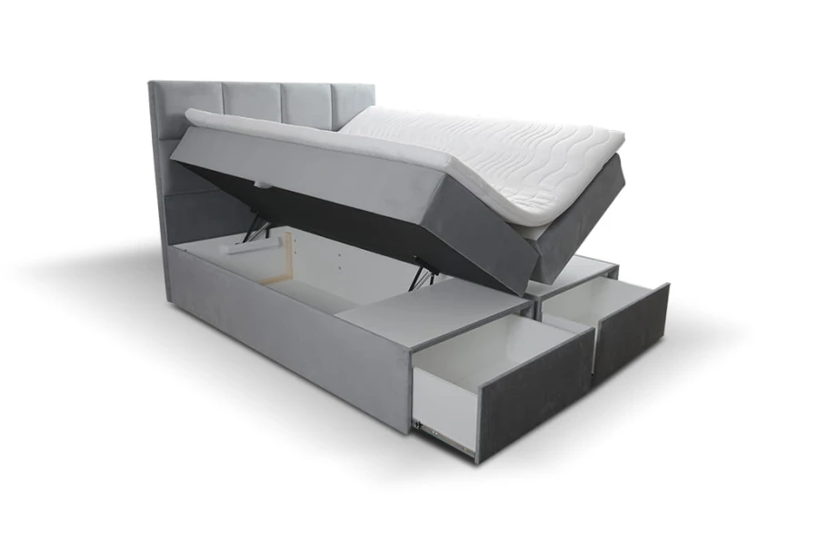 Graues Boxspringbett mit gestepptem Kopfteil, Bettkasten und Stauraumschubladen.