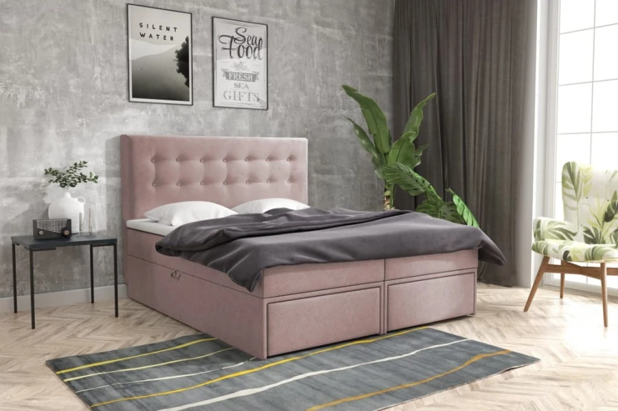 Rosa Boxspringbett mit integrierten Schubladen und elegantem Kopfende.