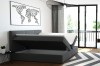Graues Boxspringbett mit aufklappbarem Bettkasten für Stauraum im Schlafzimmer