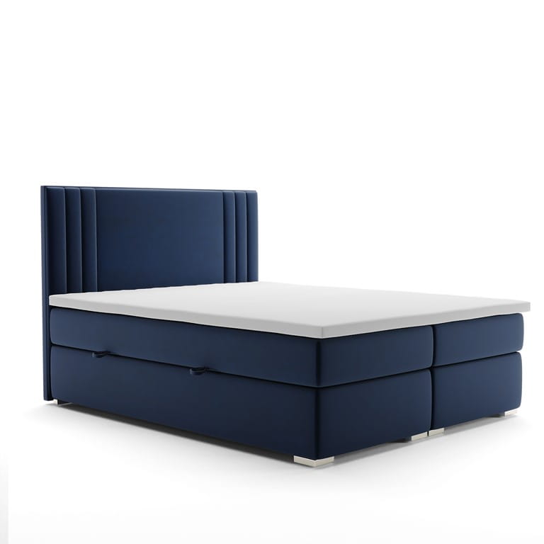 Dunkelblaues Boxspringbett mit vertikal gestepptem Kopfteil auf weißem Hintergrund.