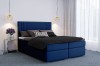 Modernes Boxspringbett in Dunkelblau mit stilvoller Dekoration in hellem Schlafzimmer.