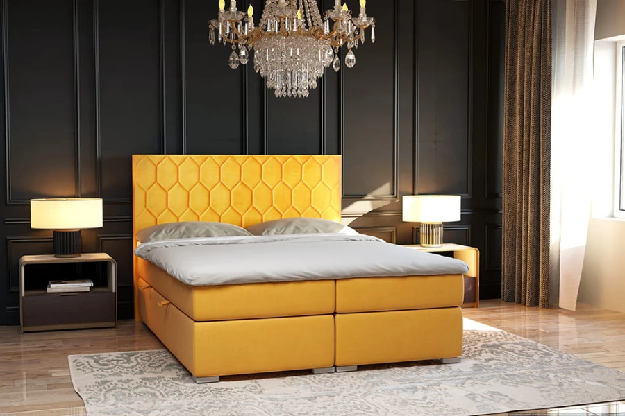 Gelbes Boxspringbett mit dekorativem Waben-Kopfteil in einem eleganten dunklen Raum.