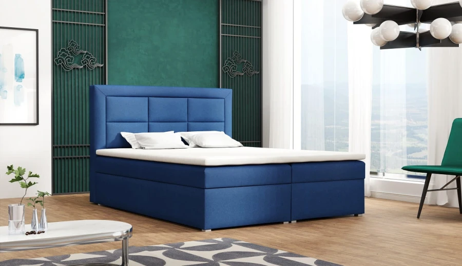 Stilvolles blaues Boxspringbett in einem eleganten Schlafzimmer mit modernen Möbeln.