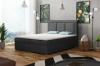 Dunkelgraues Boxspringbett mit gepolstertem Kopfteil im modernen Schlafzimmer