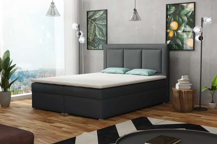 Dunkelgraues Boxspringbett mit gepolstertem Kopfteil im modernen Schlafzimmer
