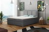 Hellgraues Boxspringbett in stilvollem Schlafzimmer mit großen Fenstern