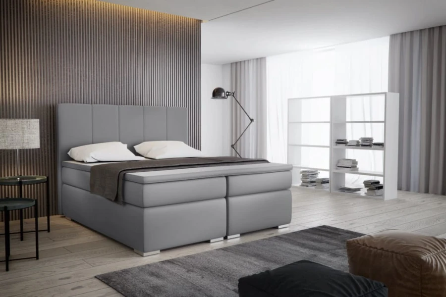 Modernes Boxspringbett in Grau mit gepolstertem Kopfteil im Schlafzimmer.
