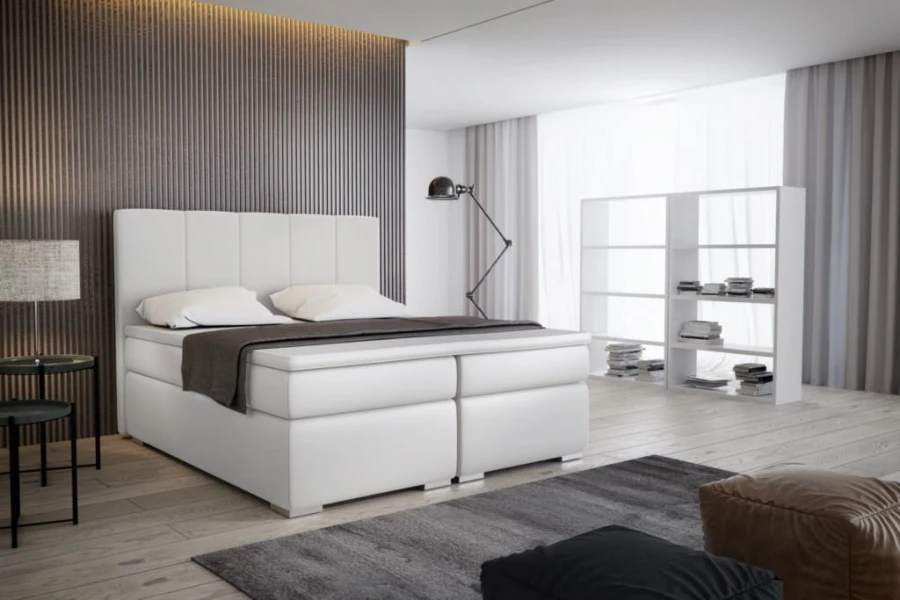 Weißes Boxspringbett in elegantem Design für moderne Schlafzimmer.