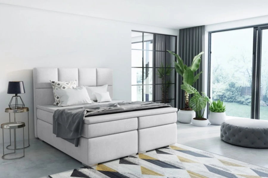 Elegantes hellgraues Boxspringbett für modernes Schlafzimmer-Design.