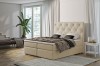 Beiges Boxspringbett mit gepolstertem Kopfteil für modernen Wohnkomfort