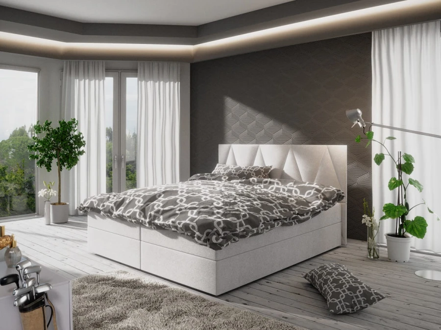 Modernes weißes Boxspringbett mit grau gemusterter Bettwäsche im hellen Schlafzimmer.