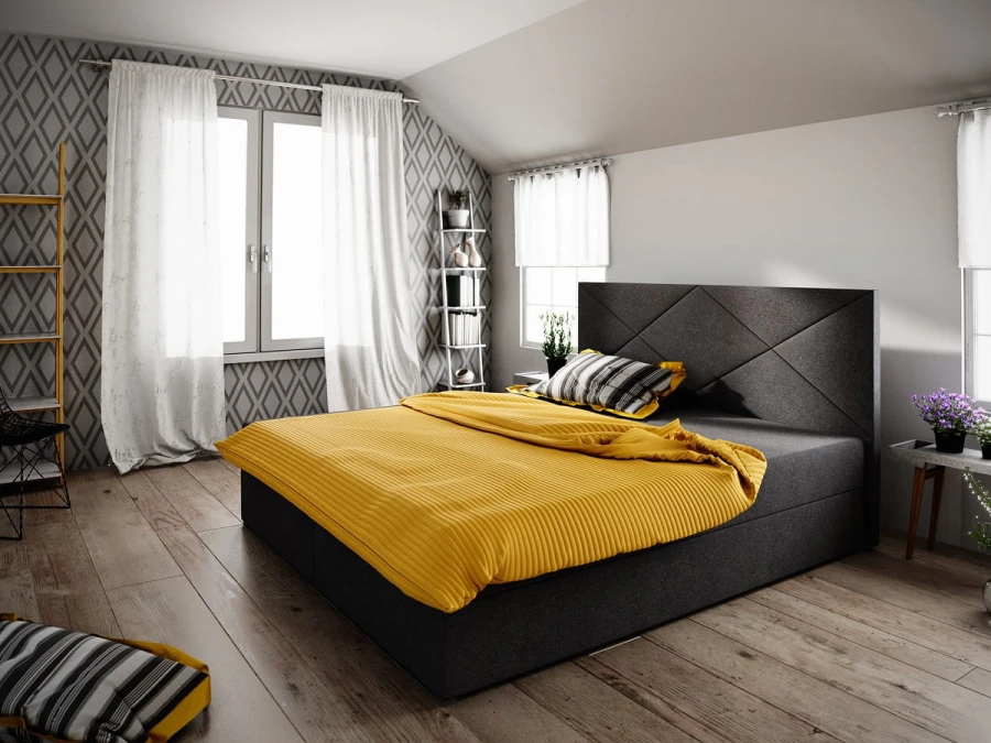 Dunkelgraues Boxspringbett mit gelber Bettwäsche als Farbakzent.