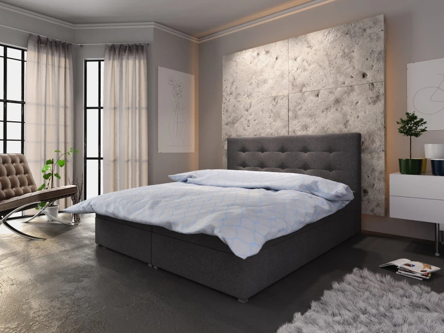 Dunkelgraues Boxspringbett mit Polsterkopfteil und moderner Bettwäsche in einem hellen Schlafzimmer.