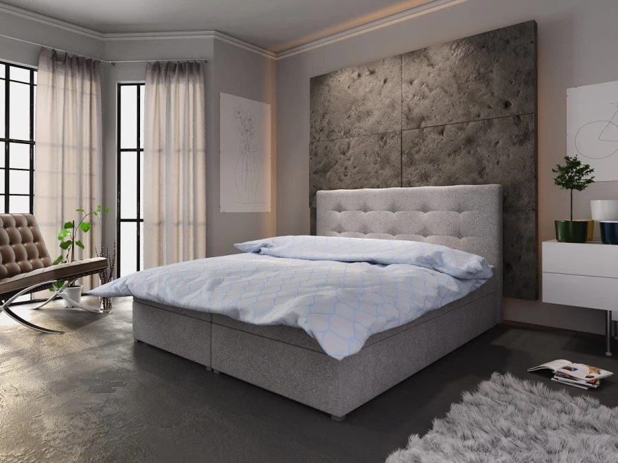 Modernes hellgraues Boxspringbett mit dekorativem Kopfteil und weichem Teppich.