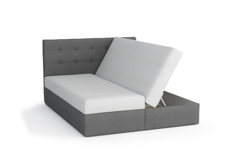 Graues Boxspringbett mit gestepptem Kopfteil und einseitig geöffnetem Bettkasten.