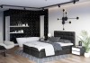 Schwarzes Boxspringbett in modernem Interieur mit Badewanne und eleganten Beleuchtungsakzenten.