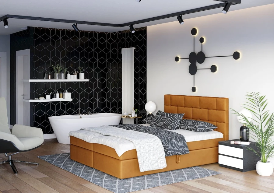 Modernes senfgelbes Boxspringbett in stilvollem Schlafzimmer mit freistehender Badewanne.
