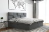 Graues Boxspringbett mit gepolstertem Kopfteil in modernem Schlafzimmer