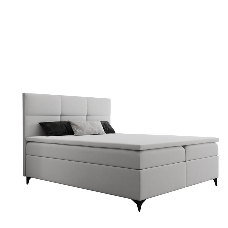 Modernes helles Boxspringbett mit horizontaler Steppung auf weißem Hintergrund.