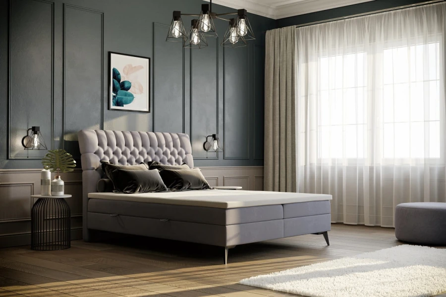 Edles graues Boxspringbett mit hoher Knopfsteppung in einem modern gestalteten Raum.
