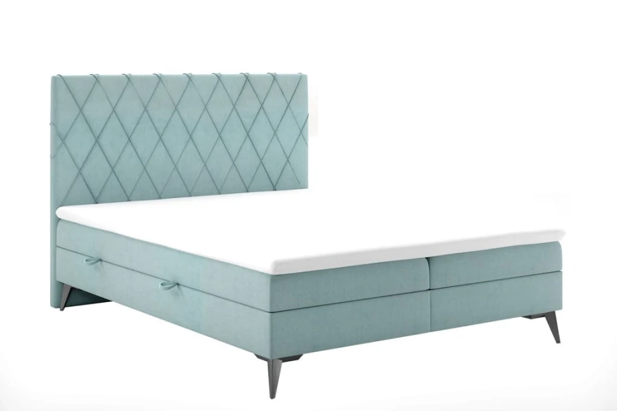 Hellblaues Boxspringbett mit Rautensteppung am Kopfteil und Bettkasten.