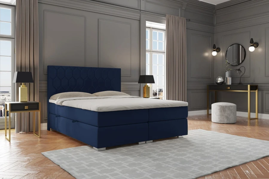 Dunkelblaues Boxspringbett in einem eleganten Schlafzimmer mit moderner Einrichtung.