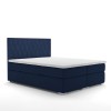 Boxspringbett in Dunkelblau mit Waben-Steppung am Kopfteil vor weißem Hintergrund.