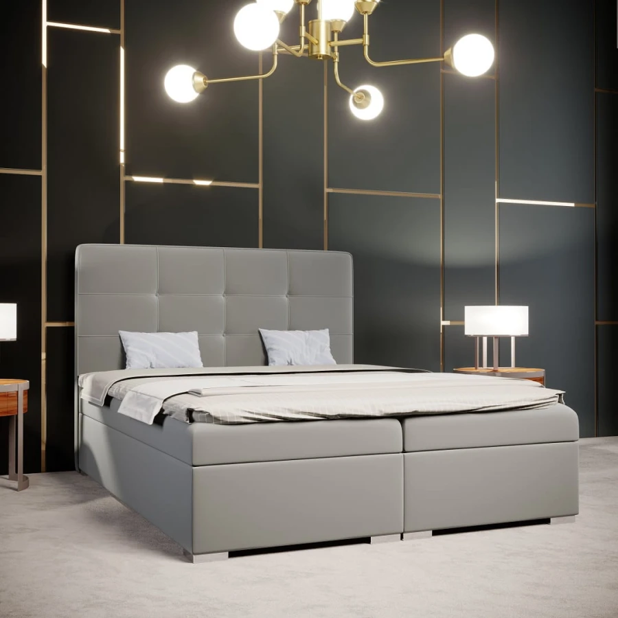 Luxuriöses graues Boxspringbett mit hohem Kopfteil in modernem, dunklem Schlafzimmer.