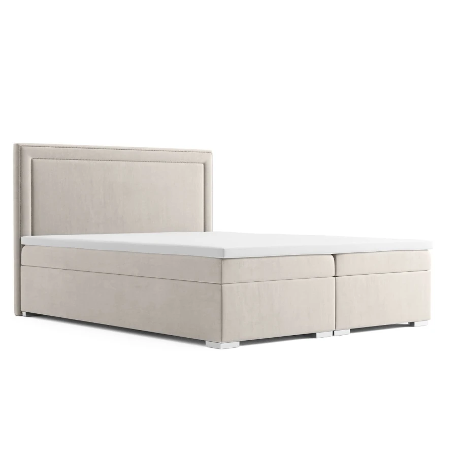 Klassisches beige Boxspringbett mit gepolstertem Kopfteil auf weißem Hintergrund.