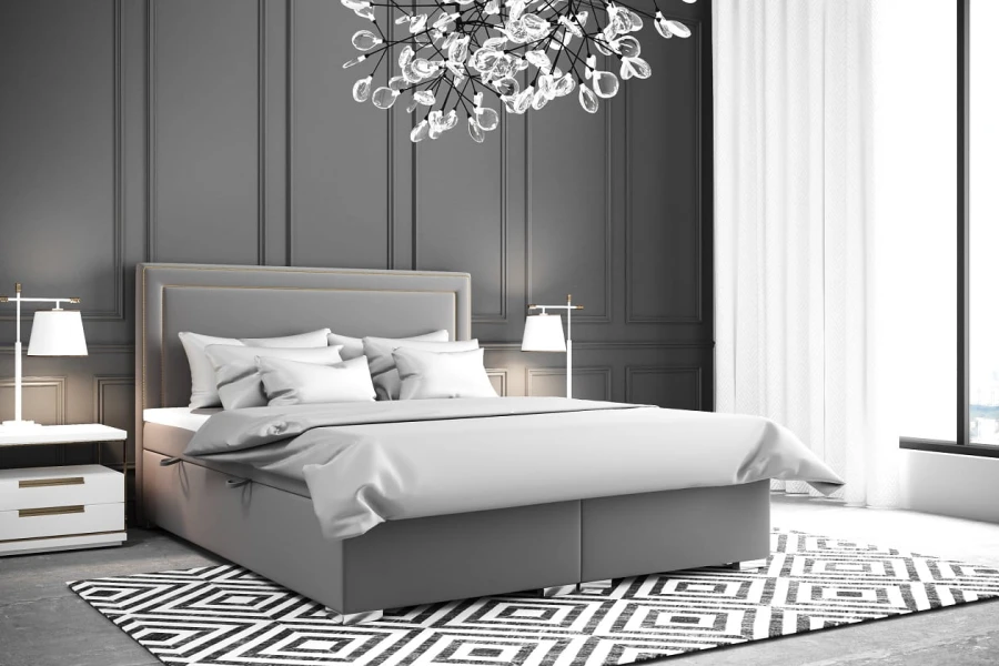 Graues Polsterbett in modernem Schlafzimmer mit schwarz-weißem Teppich und Designerlampe.