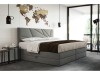 Modernes Polsterbett in Grau mit geometrischem Kopfteil und Bettwäsche im Schlafzimmer.