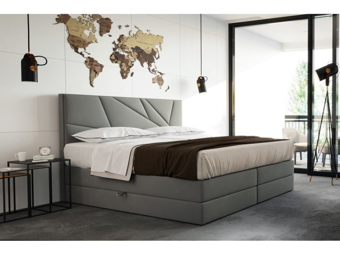 Modernes Polsterbett in Grau mit geometrischem Kopfteil und Bettwäsche im Schlafzimmer.