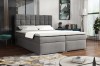 Modernes Boxspringbett in Grau mit gestepptem Kopfteil im stilvollen Schlafzimmer.