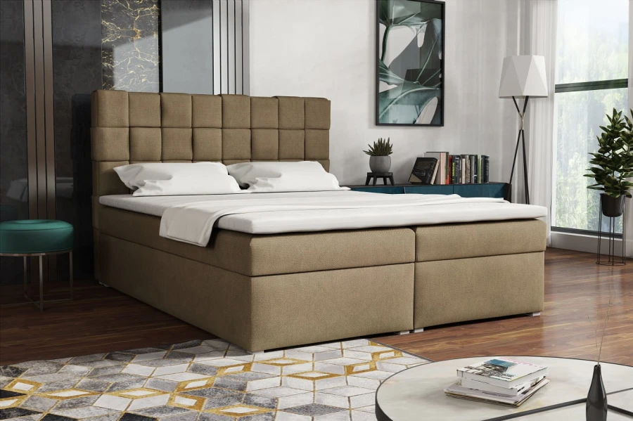 Beiges Boxspringbett mit quadratischer Steppung im Kopfteil für Schlafkomfort.