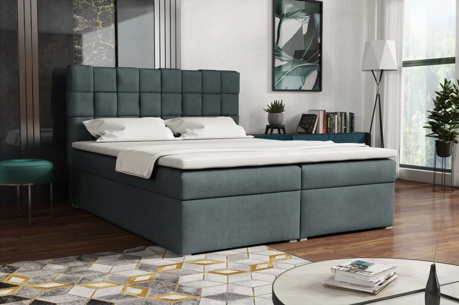 Modernes graues Polsterbett mit gestepptem Kopfteil im Schlafzimmer.