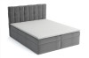 Modernes graues Boxspringbett mit gestepptem Kopfteil und weißem Topper.