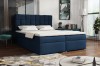 Dunkelblaues Boxspringbett in modernem Schlafzimmer-Ambiente mit Samtbezug.