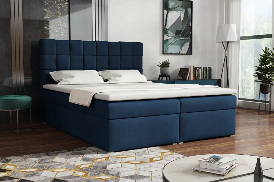 Dunkelblaues Boxspringbett in modernem Schlafzimmer-Ambiente mit Samtbezug.