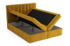 Gelbes Boxspringbett mit zwei offenen Bettkästen für viel Stauraum.