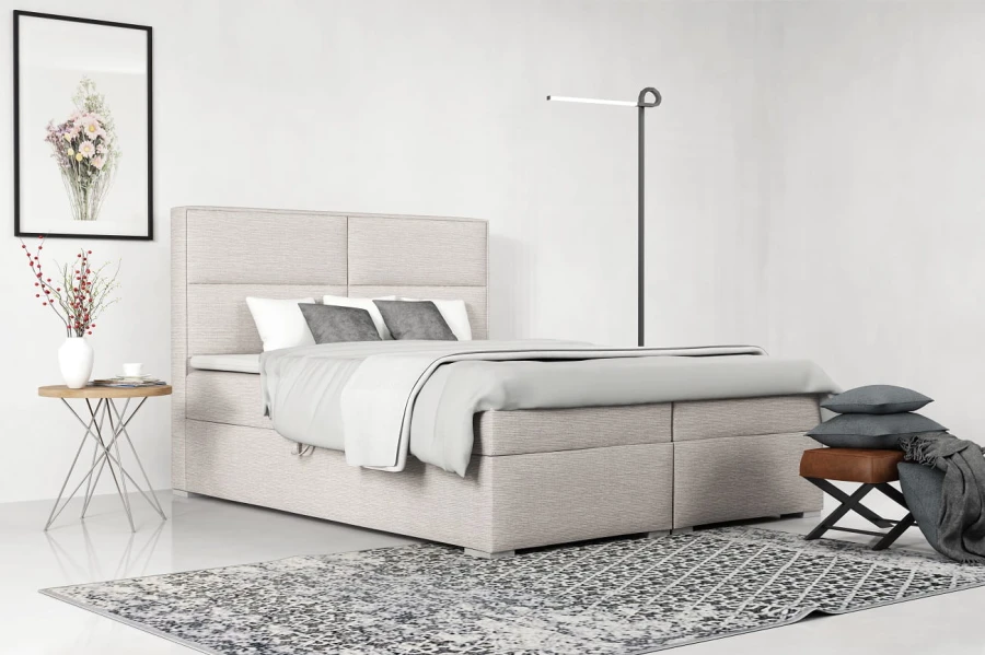 Modernes Boxspringbett in Beige mit hohem, gepolstertem Kopfteil im hellen Schlafzimmer.