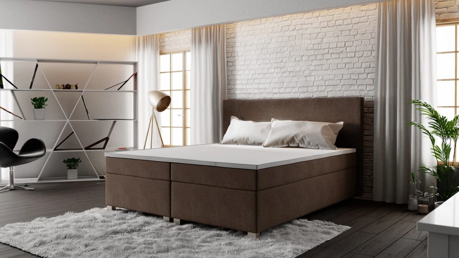 Braunes Boxspringbett in modernem Schlafzimmer mit weißer Backsteinwand.