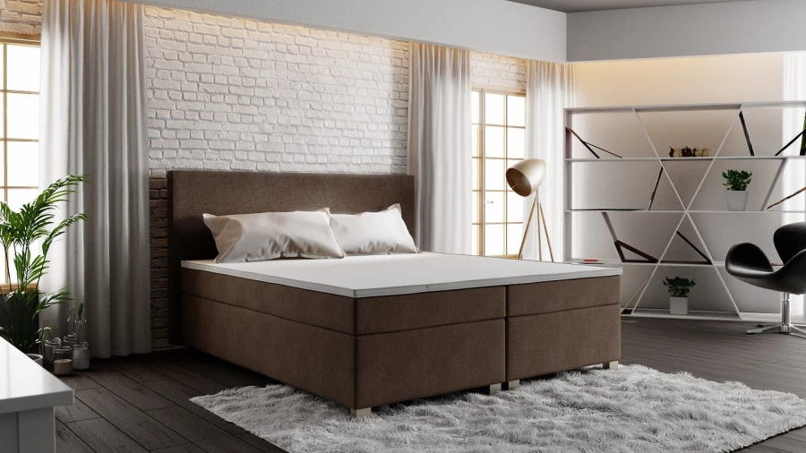 Modernes Boxspringbett in Braun, Seitenansicht im hellen Schlafzimmer.
