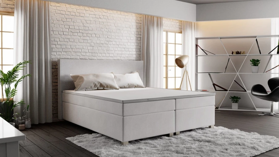 Weißes Boxspringbett aus einer anderen Perspektive im modernen Raum.