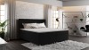 Schwarzes Boxspringbett in einem Schlafzimmer im Loft-Stil.