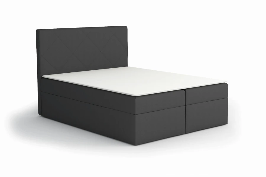 Dunkelgraues Boxspringbett mit Rautensteppung am Kopfteil, freigestellt.