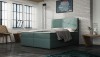Petrolfarbenes Boxspringbett mit modernem Design im Schlafzimmer mit Loft-Stil.