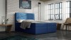 Blaues Boxspringbett mit stilvoller Rautensteppung im modernen Loft-Schlafzimmer.