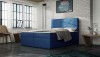 Blaues Boxspringbett mit gestepptem Kopfteil in modernem Schlafzimmer.